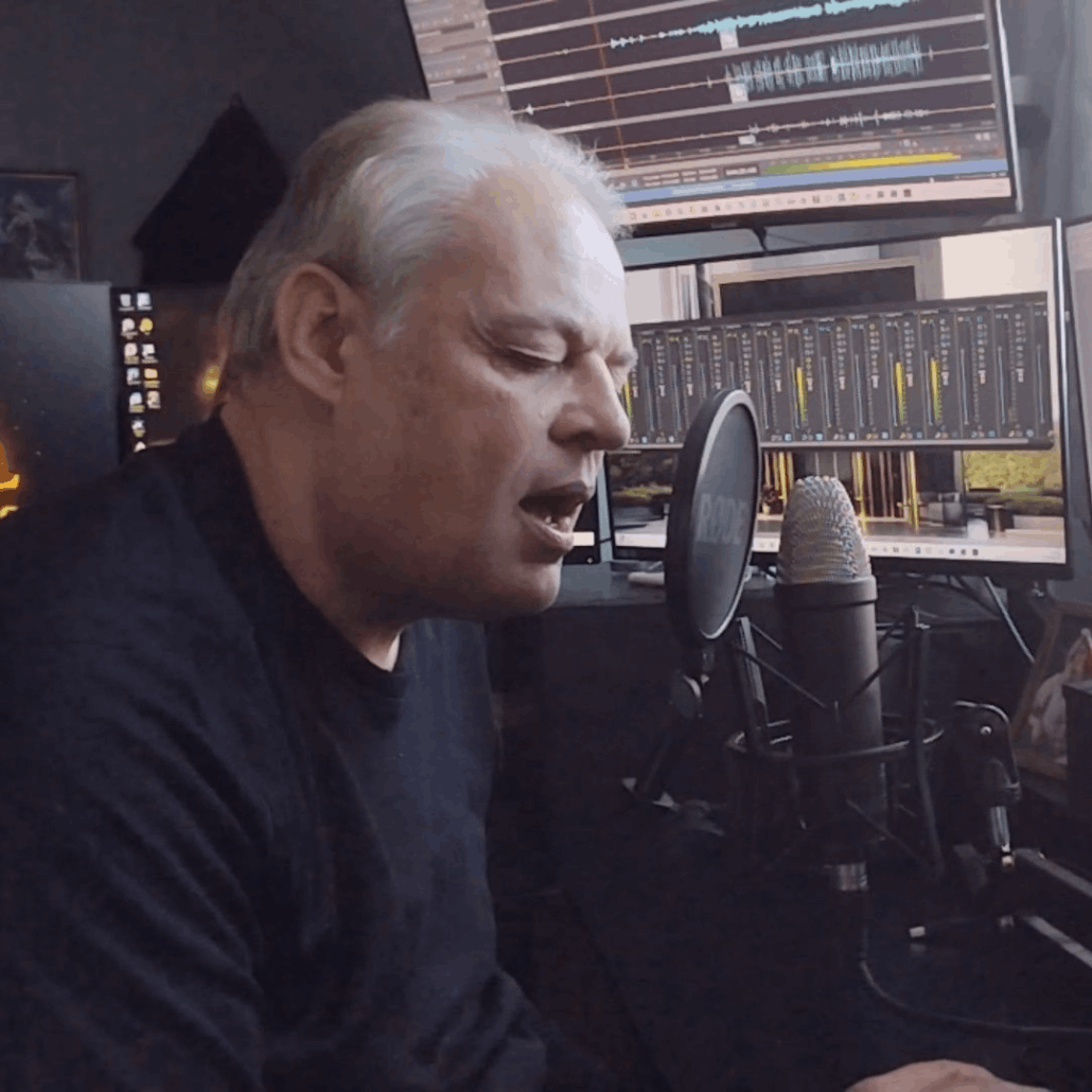 Kris McClearn singing into microphone during recording session